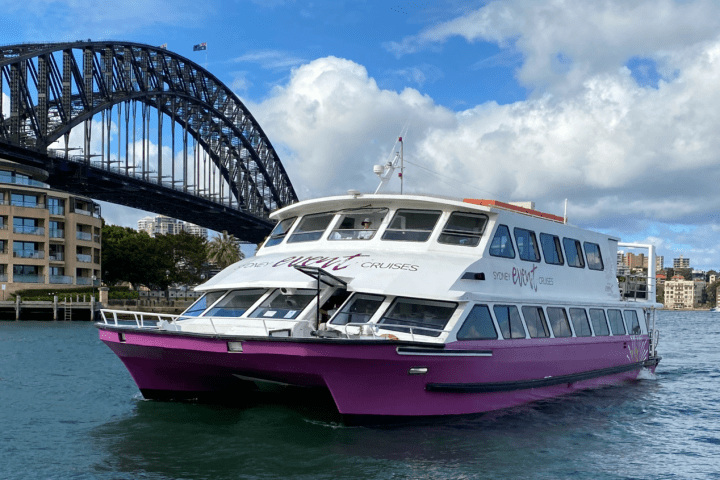 MV Supercat catamaran on the water in front of Sydney Harbour Bridge